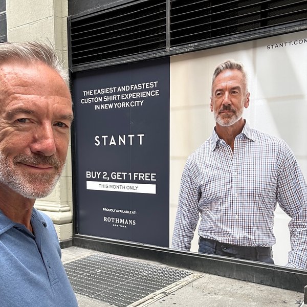 Clayton Paterson poses near his billboard